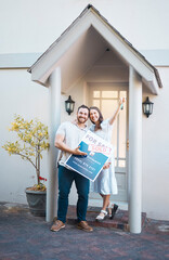 Young caucasian couple holding house keys while moving into new apartment. Happy man and woman...