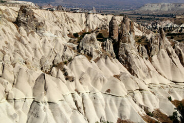 Landscape with the magical white chimneys (also called mushrooms) in Love Valley near Goreme in Cappadocia, Turkey	
