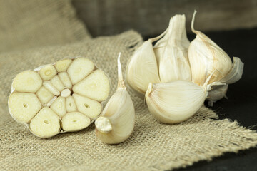Fresh garlic close-up, cloves of garlic on a wooden background.