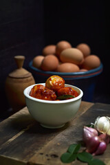 Balado Egg Sambal, a typical Indonesian food. on a wooden board