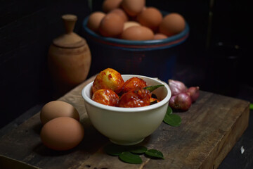 Balado Egg Sambal, a typical Indonesian food. on a wooden board