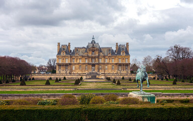 View of the park and the old Chateau Maison or Chateau Maison-Laffitte in the suburbs of Paris in cloudy weather.