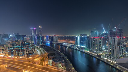 Fototapeta na wymiar Skyscrapers at the Business Bay aerial night timelapse in Dubai, United Arab Emirates