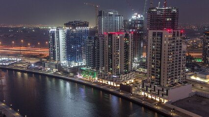 Fototapeta na wymiar Towers at the Business Bay aerial day to night timelapse in Dubai, United Arab Emirates