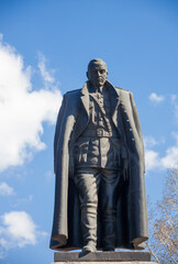 Figure of Admiral Kolchak on the monument in Irkutsk against the blue sky.