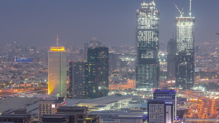 Aerial view of skyscrapers with World Trade center in Dubai day to night timelapse.