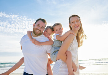 Happy family at the beach. Portrait of smiling young parents with children having fun on vacation. Little boy and girl enjoying summer with mother and father