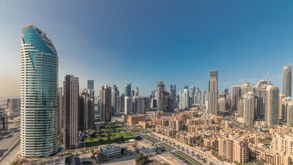 Obraz premium Panorama showing Dubai's business bay towers aerial morning timelapse. Rooftop view of some skyscrapers