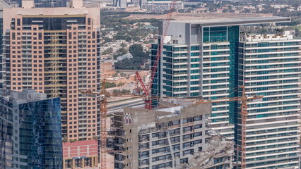 High multi-storey buildings under construction and cranes timelapse