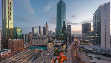 Naklejka na ściany i meble Dubai International Financial district aerial night to day timelapse. Panoramic view of business office towers.