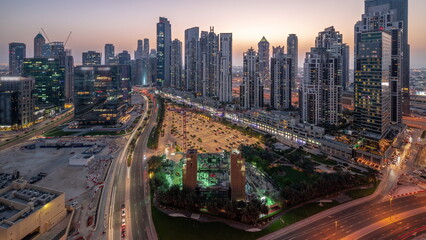Fototapeta na wymiar Bay Avenue with modern towers residential development in Business Bay aerial panoramic day to night timelapse, Dubai