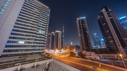 Aerial panoramic view to Dubai downtown and difc skyscrapers all night timelapse.