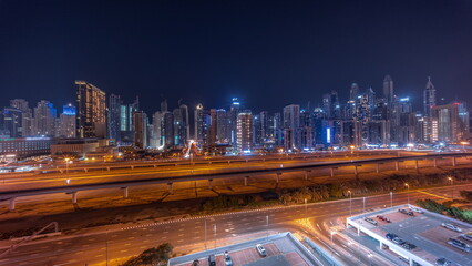 Fototapeta premium Panorama of Dubai marina tallest block of skyscrapers all night timelapse.