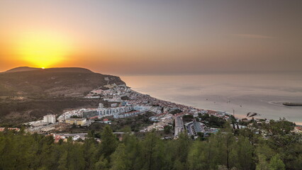 Aerial sunrise view of the coastline of the village of Sesimbra timelapse. Portugal