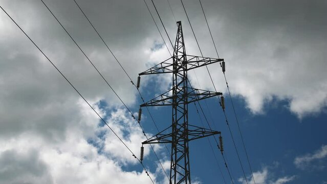 Power line pylon against the background of the sky. Timelapse with dark clouds and lights clouds	

