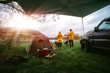 Sunbeam, couple, man and woman on vacation in wilderness. preparing the camp, The couple is...