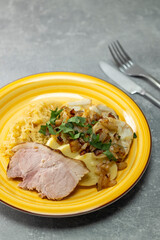 pork meat with potato dumplings and pickled cabbage served with roasted onion