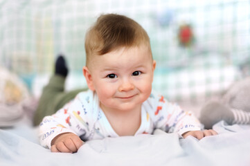 Portrait of cute baby boy looking at camera. Joy and happiness concept. Love and family emotion