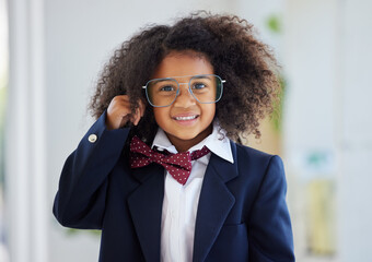 Go on, Im listening. Shot of an adorable little girl dressed as a businessperson standing alone in...