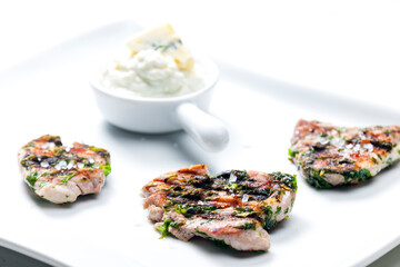 grilled poultry meat with herbs served with blue cheese dip
