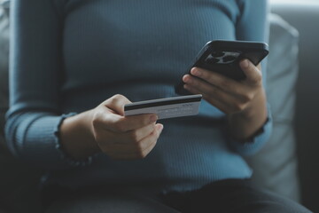 Close up of woman hand using credit card and laptop for payment and online shopping, Online shopping, payments digital banking, E-commerce concept.