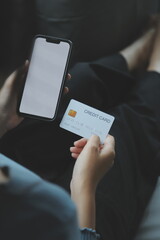 Close up of woman hand using credit card and laptop for payment and online shopping, Online shopping, payments digital banking, E-commerce concept.