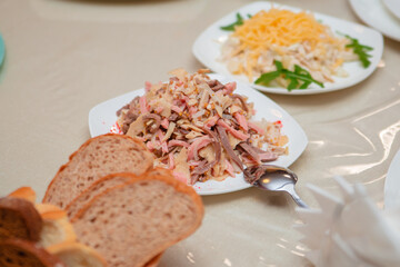 Calamari salad. Seafood fish dish in a white plate on the table.