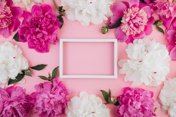 Composition of white and pink peonies and white empty frame with copy space, beautiful floral background, fashion, glamour, flat lay