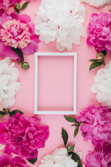 Composition of white and pink peonies and white empty frame with copy space, beautiful floral background, fashion, glamour, flat lay