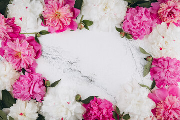 Pink and white peonies on a white marble background, copy space, flat lay, greeting card.