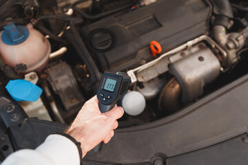 Measuring temperature of internal combustion Engine turbine by laser infrared thermometer - obrazy, fototapety, plakaty