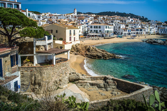 A classic white town on the Costa Brava. White houses, historical buildings of Calella de Palafrugell. Rocks, beach and sea view