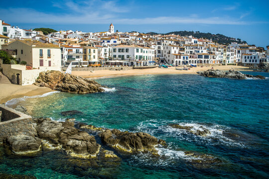 A classic white town on the Costa Brava. White houses, historical buildings of Calella de Palafrugell. Rocks, beach and sea view