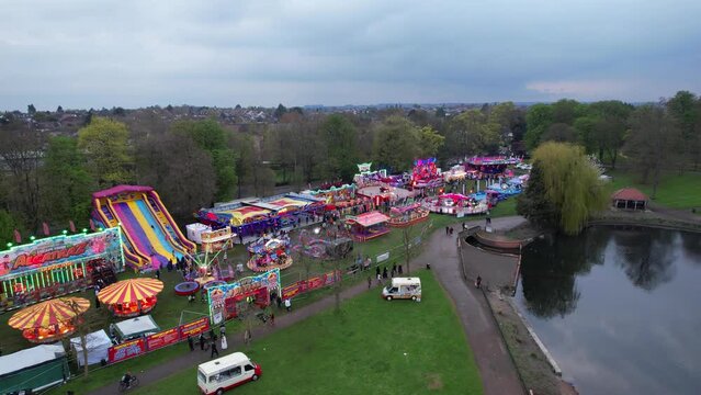 High Angle Footage of Public Funfair Held at Wardown Public Park of Luton with Free Access for Muslim Community on Islamic Holy Eid Festival Day. Captured with Drone's Camera on April 23rd, 2023 