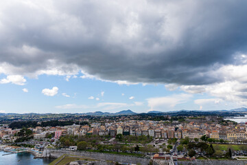 Fototapeta na wymiar Thick clouds over the city. A beautiful landscape of the island of Corfu in Greece. 