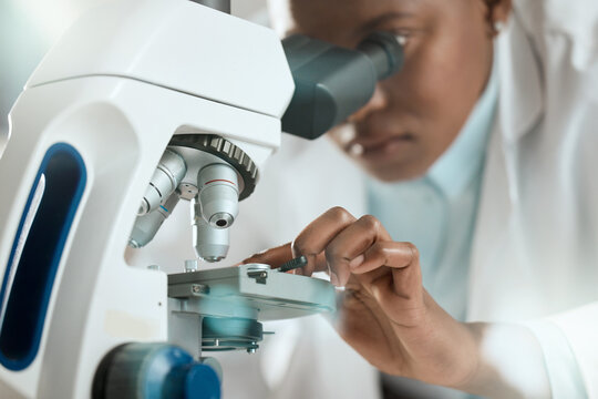 I might be able to see the problem. Shot of an unrecognisable scientist using a microscope to analyse a sample in the laboratory.