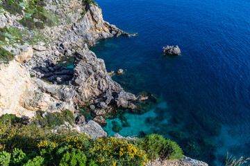Obraz premium A beautiful landscape of the coast of the island of Corfu in the Ionian Sea of the Mediterranean in Greece. Pure blue clear water washes over the shores of the Greek island.