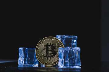 Ice and bitcoin coin. Freezing of cryptocurrency accounts. Frozen bitcoin coin.