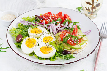 Fresh  salad with tomato, olives, boiled eggs and and sandwich with  ricotta cheese, avocado.