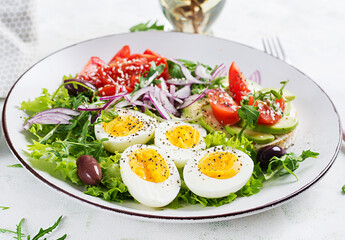 Fresh  salad with tomato, olives, boiled eggs and and sandwich with  ricotta cheese, avocado.
