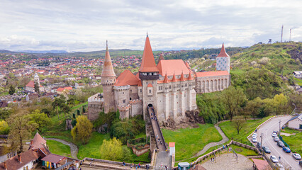 Aerial view of the Huniyad castle in Hunedoara, Romania in spring season, on a rainy day. Photography was shot from a drone at a lower altitude with the castle in the view. 