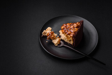 Delicious fresh cheesecake cake or snickers with cream and nuts