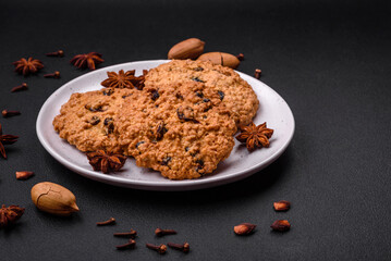 Delicious baked oatmeal raisin cookies on a dark concrete background