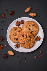Delicious baked oatmeal raisin cookies on a dark concrete background