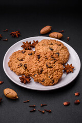 Delicious baked oatmeal raisin cookies on a dark concrete background