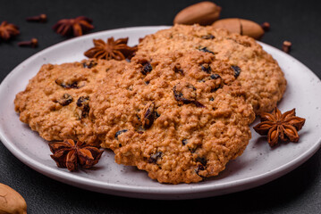 Delicious baked oatmeal raisin cookies on a dark concrete background