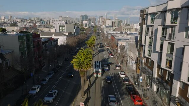 Forwards tracking on historic streetcar PCC on Market street. Wide boulevard with row of palm trees in middle.