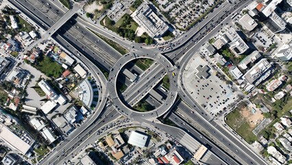 Aerial drone photo of multilevel circular ring road junction passing through urban city centre connecting National motorway and popular avenue