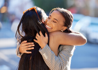 How long has it been. Cropped shot of two attractive young girlfriends hugging while out on the...