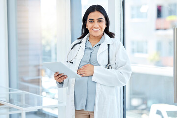 Ill be in the maternity ward quite soon too. Portrait of a pregnant doctor using a digital tablet...